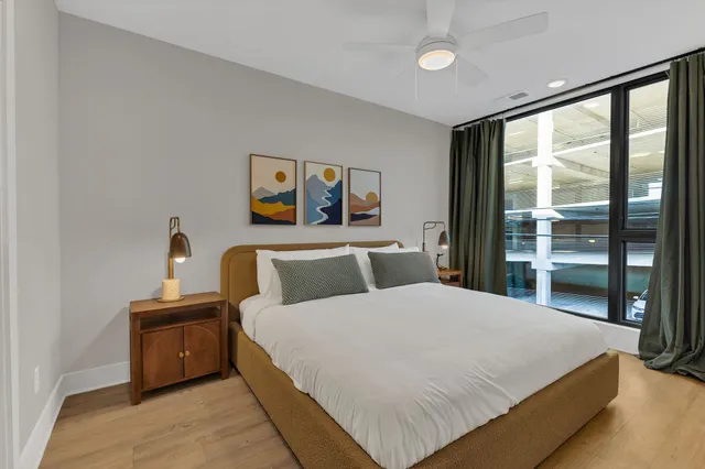 a bedroom with a large bed and a large window