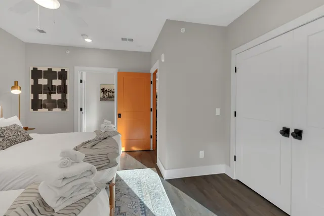 a bedroom with a bed and wooden floor