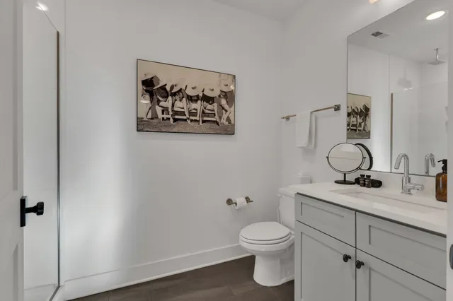 a bathroom with a toilet sink and vanity
