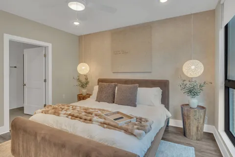 a bedroom with a bed and a potted plant