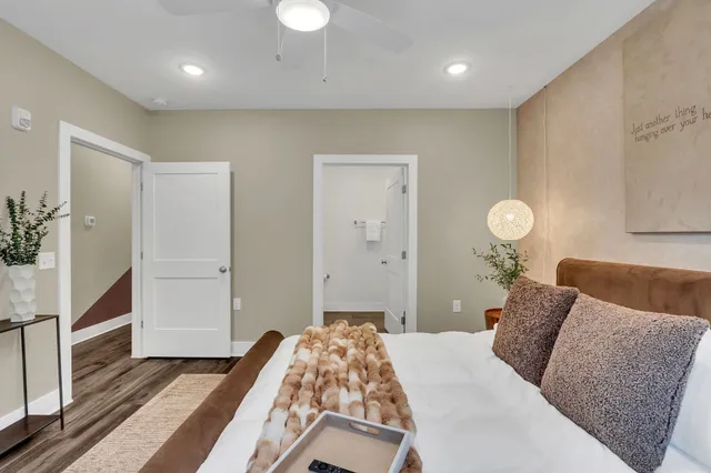 a bedroom with a bed and a chandelier