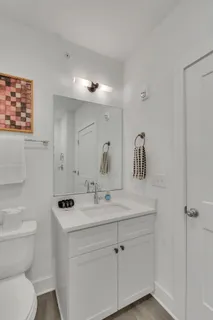 a bathroom with a toilet sink and mirror