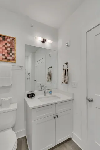 a bathroom with a toilet sink and mirror