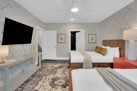 a bedroom with a bed and a flat screen television