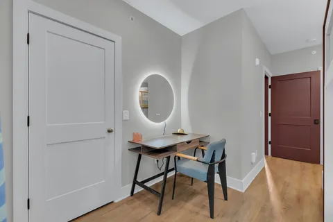 a workspace with furniture and a mirror