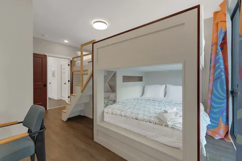 a bedroom with a bed and a mirror