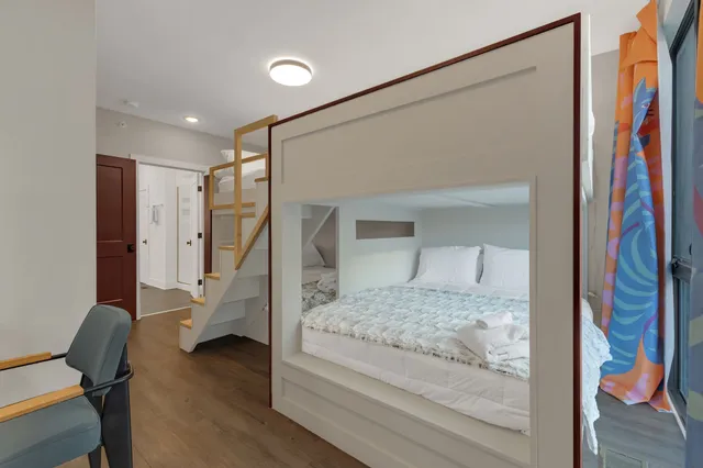 a bedroom with a bed and a mirror