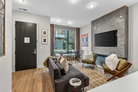 a living room with furniture fireplace and a flat screen tv