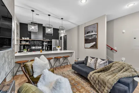 a living room with furniture and kitchen view