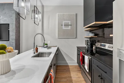 a kitchen with a sink appliances and cabinets