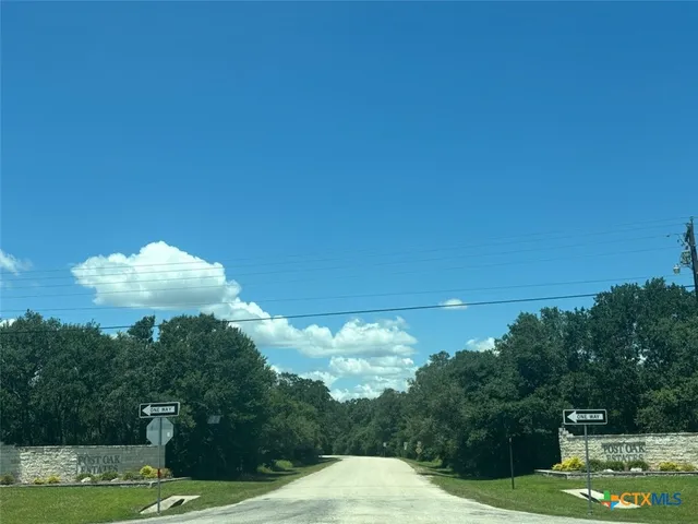 a view of a big yard with an outdoor space and seating area