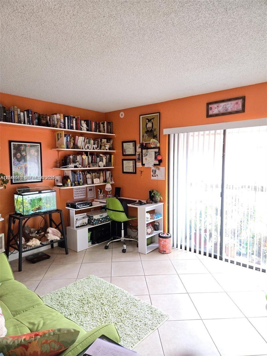 2174 West 60th Street, Unit 17205 Hialeah, FL 33016 - Photo 10 of 11 a reading room with furniture a rug and a window
