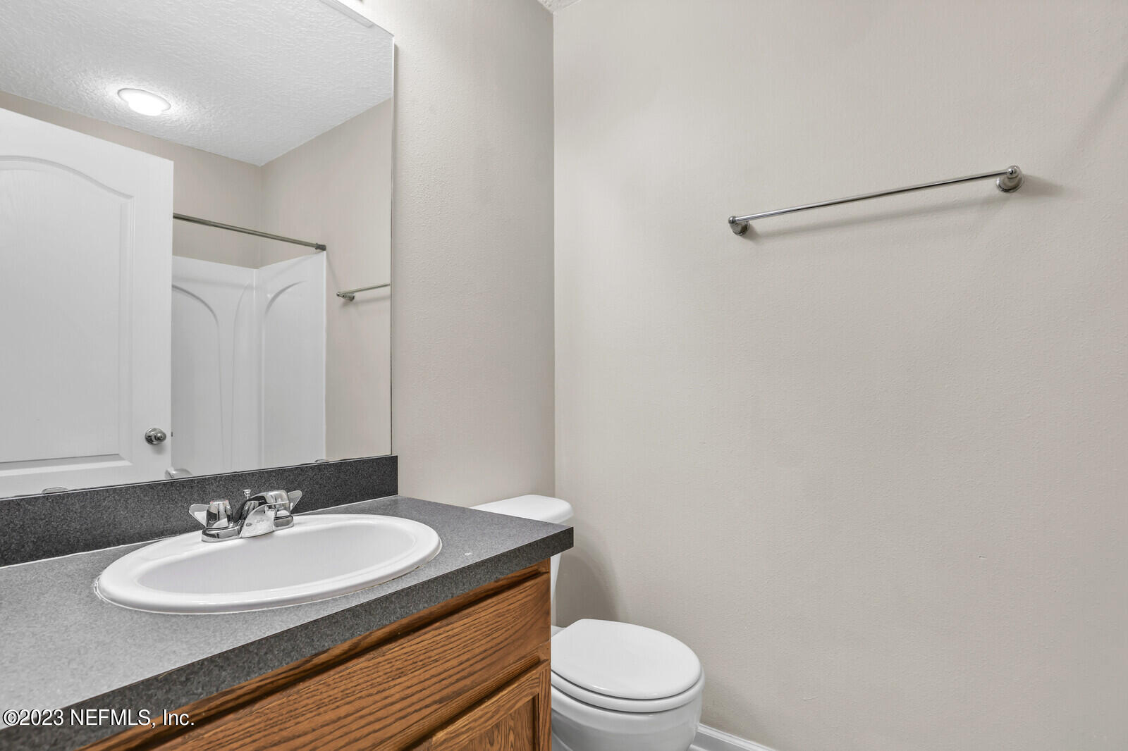 1810 Biscayne Bay Circle Jacksonville, FL 32218 - Photo 12 of 15 a bathroom with a granite countertop sink toilet a mirror and shower