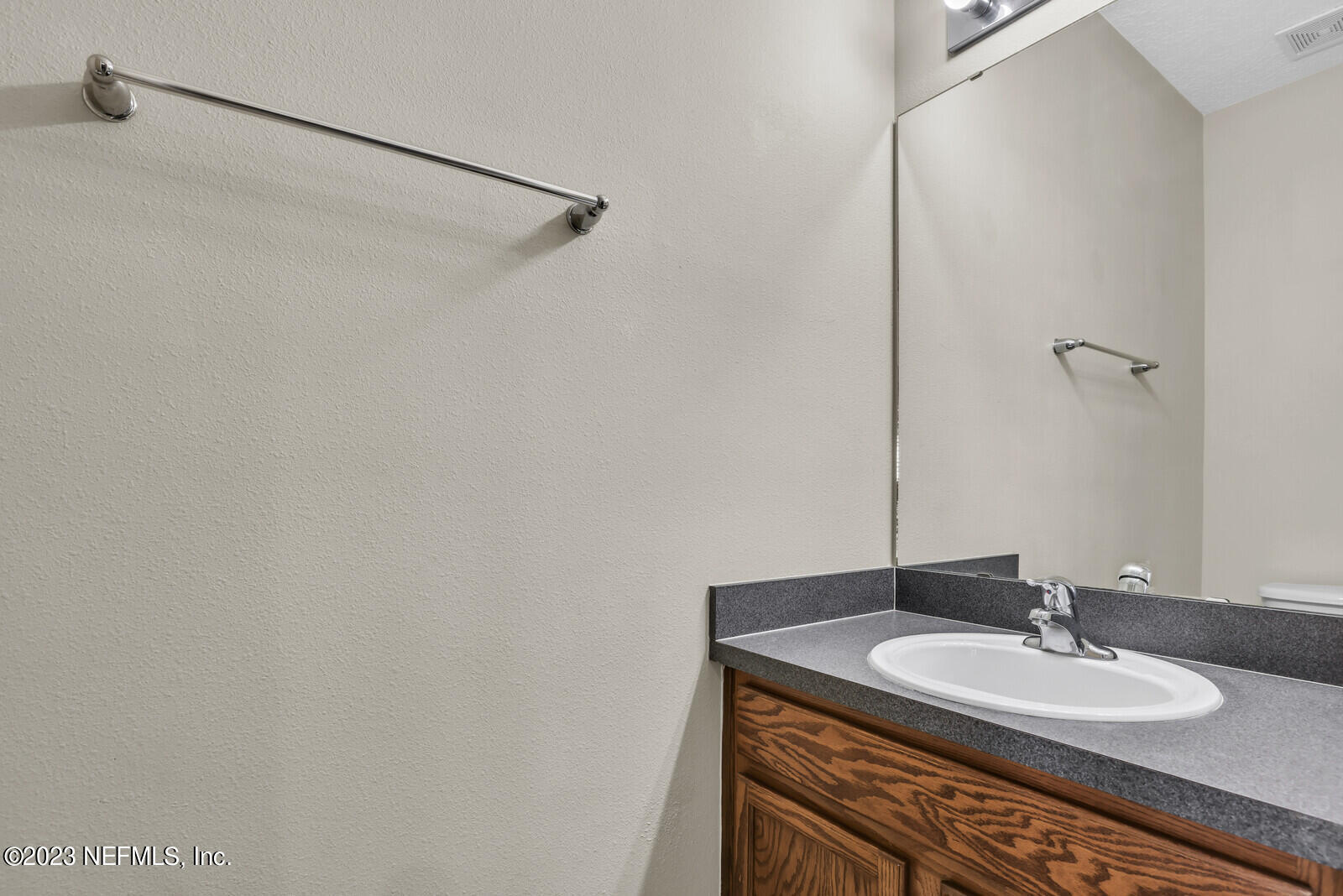 1810 Biscayne Bay Circle Jacksonville, FL 32218 - Photo 8 of 15 a bathroom with a granite countertop sink and a mirror