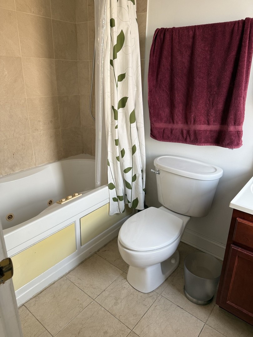 4027 West Crystal Street, Unit 2 Chicago, IL 60651 - Photo 13 of 14 a white toilet sitting next to a bath tub