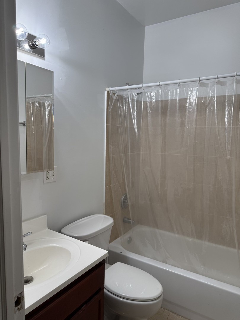 4027 West Crystal Street, Unit 2 Chicago, IL 60651 - Photo 14 of 14 a bathroom with a sink a toilet and shower