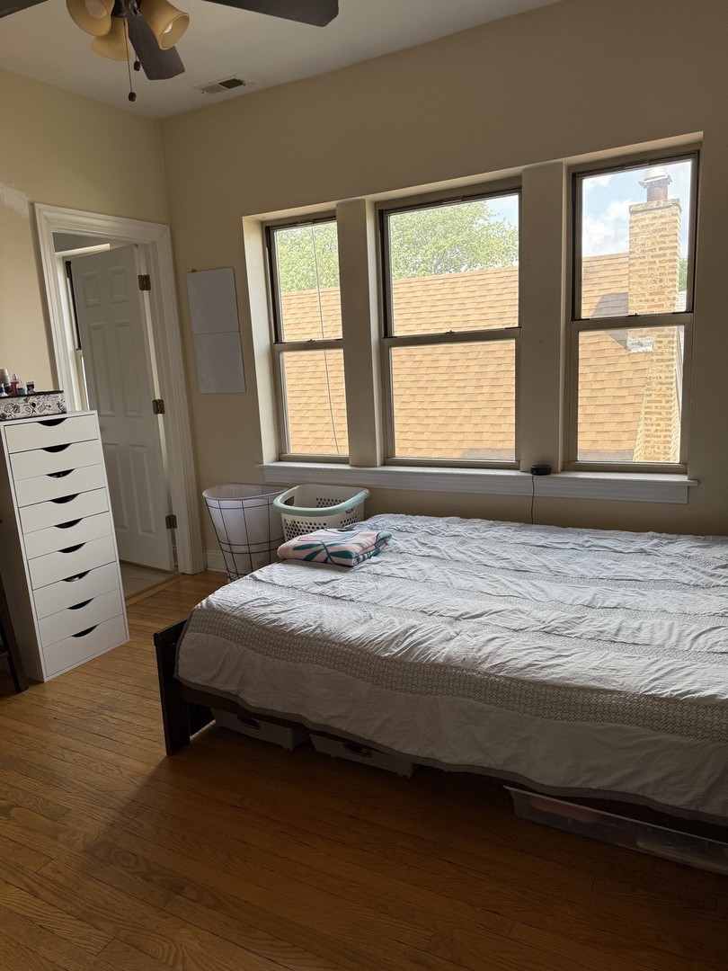 4027 West Crystal Street, Unit 2 Chicago, IL 60651 - Photo 9 of 14 a bedroom with a bed and a window