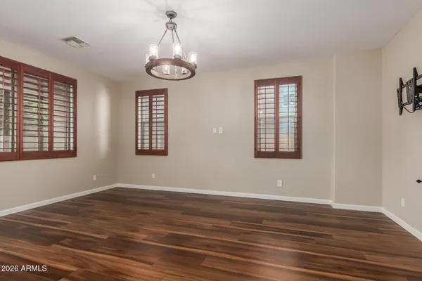 a view of empty room with wooden floor and window