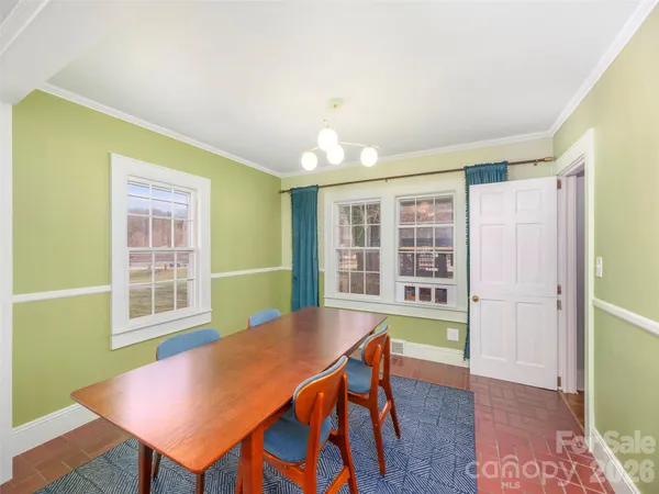 a view of a dining room with furniture and a window