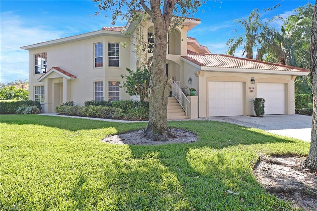 a front view of house with yard and green space