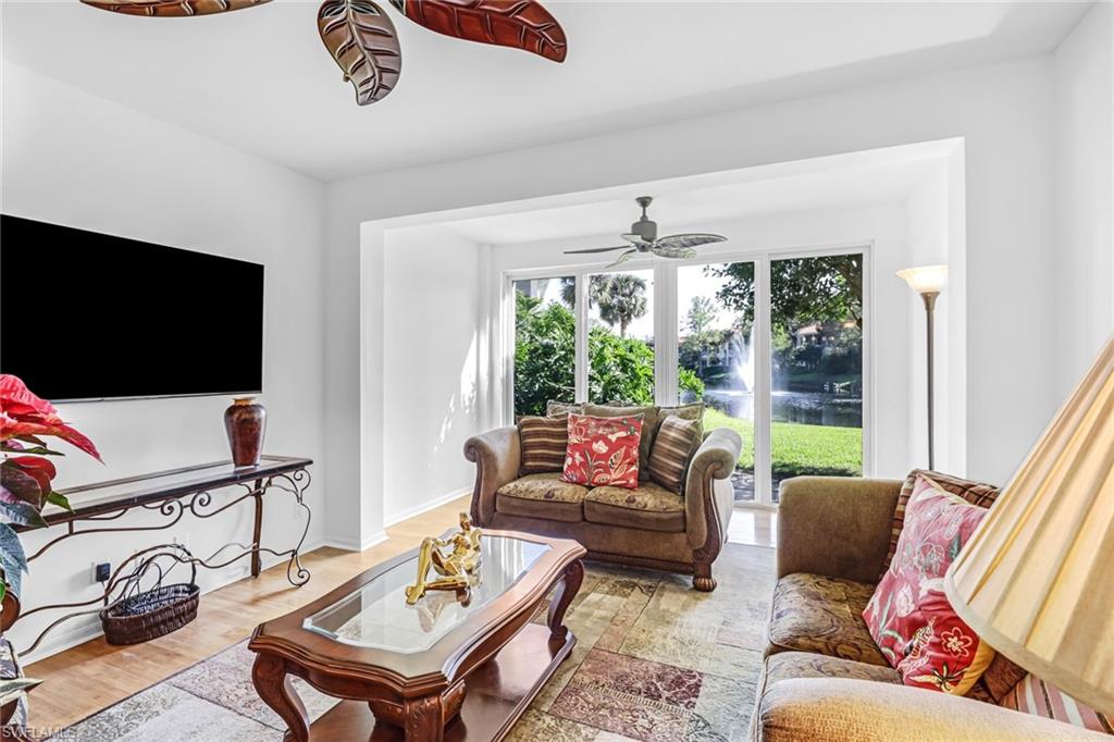 1301 Egrets Landing, Unit 101 Naples, FL 34108 - Photo 11 of 25 a living room with furniture and a flat screen tv