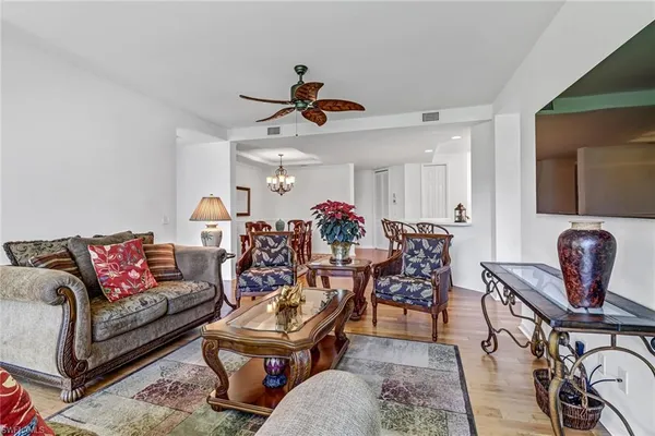 a living room with furniture a flat screen tv and a window