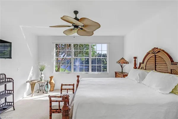 a bed sitting in a bedroom next to a window