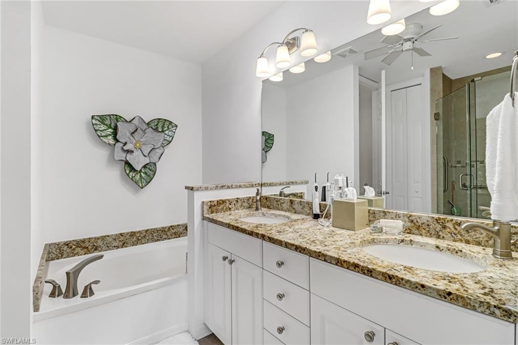 1301 Egrets Landing, Unit 101 Naples, FL 34108 - Photo 18 of 25 a bathroom with a granite countertop sink and a mirror
