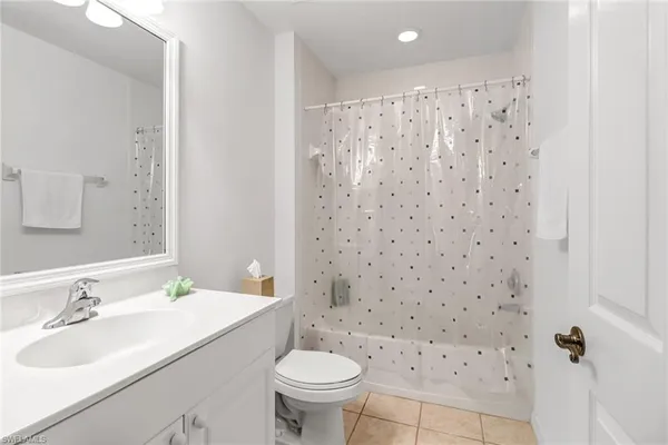 a bathroom with a sink toilet and a mirror