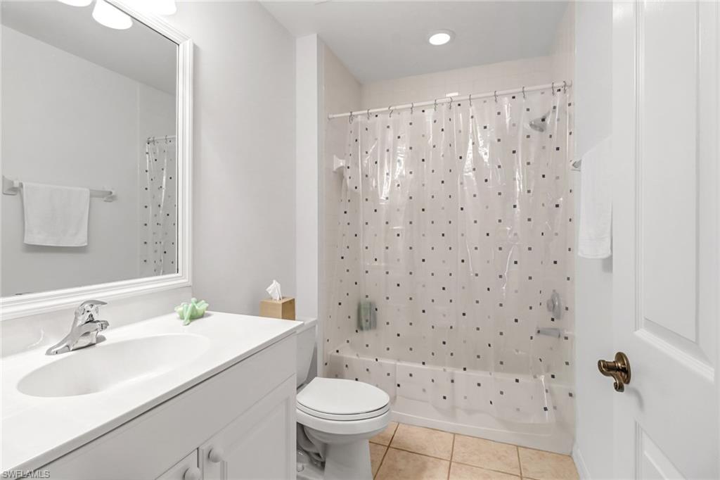 1301 Egrets Landing, Unit 101 Naples, FL 34108 - Photo 22 of 25 a bathroom with a sink toilet and a mirror
