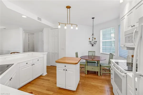 a room with a baby bed a desk and chair