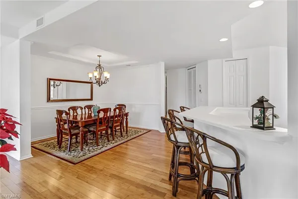 a view of a dining room with furniture and chandelier
