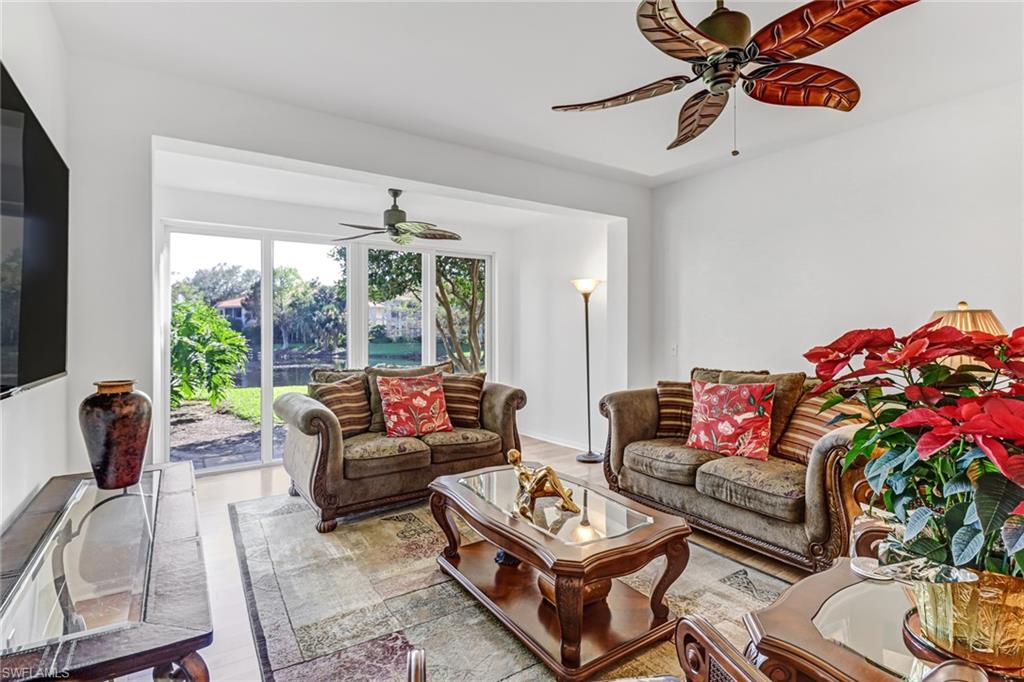 1301 Egrets Landing, Unit 101 Naples, FL 34108 - Photo 10 of 25 a living room with furniture and a large window