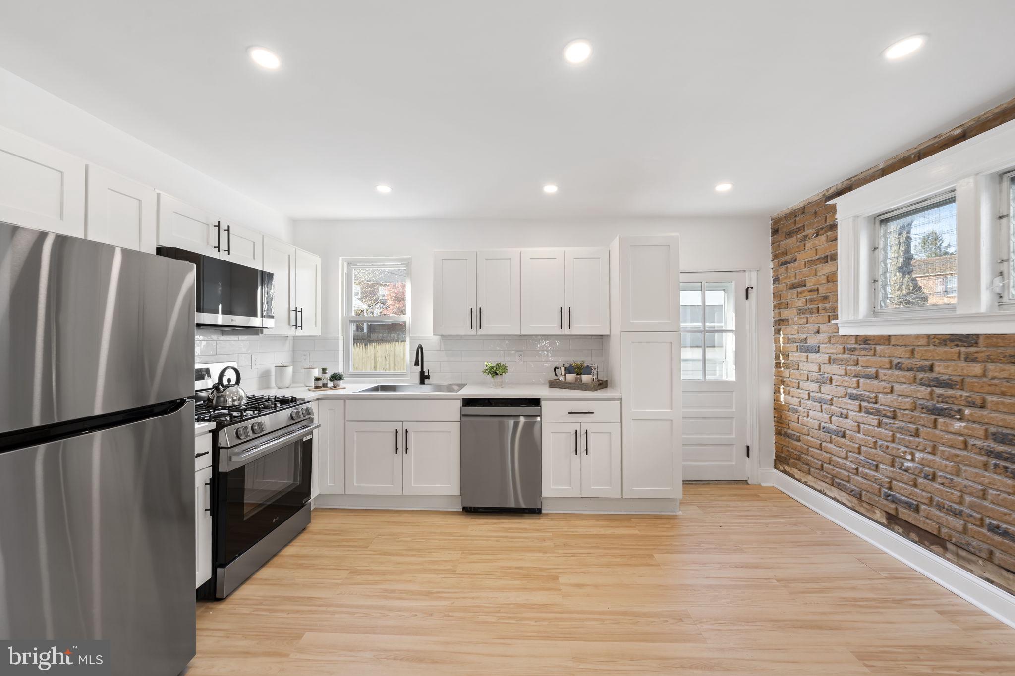 2517 Marshall Road Drexel Hill, PA 19026 - Photo 12 of 29 a kitchen with stainless steel appliances granite countertop a refrigerator and a stove top oven
