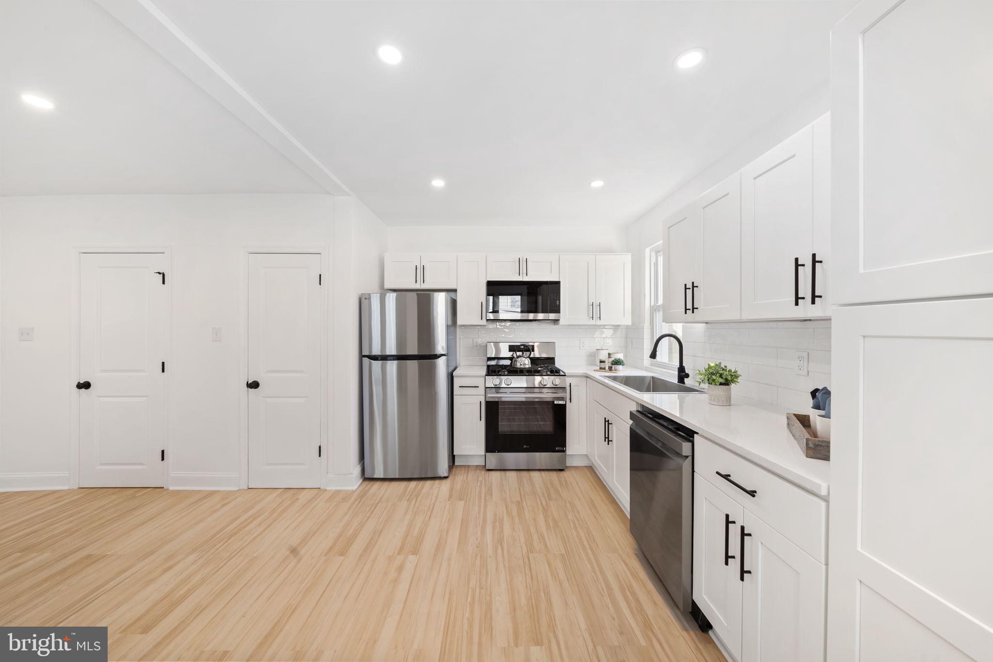 2517 Marshall Road Drexel Hill, PA 19026 - Photo 16 of 29 a kitchen with stainless steel appliances a refrigerator sink and white cabinets