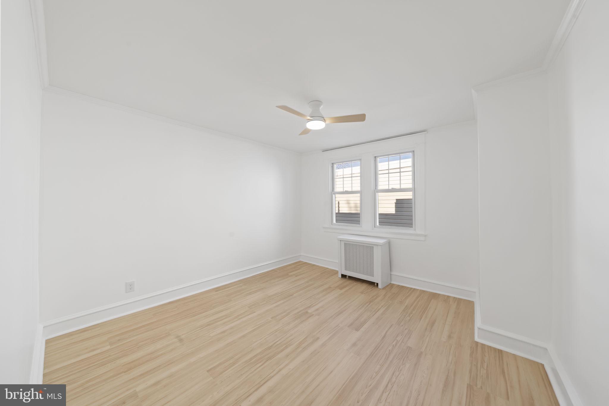 2517 Marshall Road Drexel Hill, PA 19026 - Photo 25 of 29 an empty room with wooden floor and windows