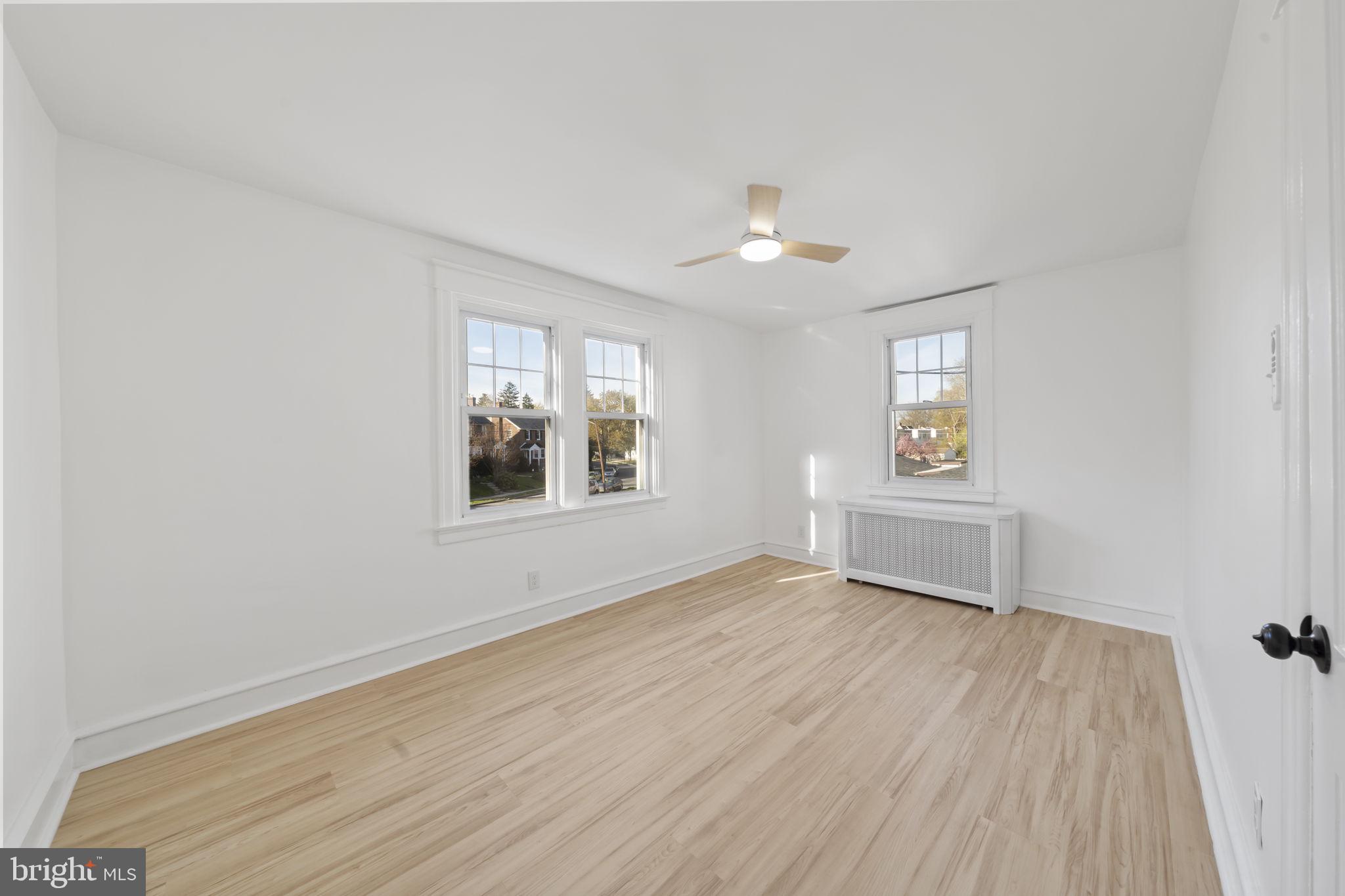 2517 Marshall Road Drexel Hill, PA 19026 - Photo 26 of 29 a view of an empty room with a window and wooden floor