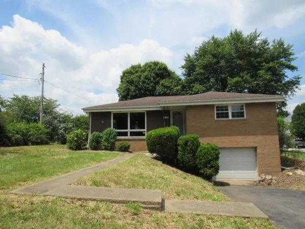 a front view of house with yard and green space