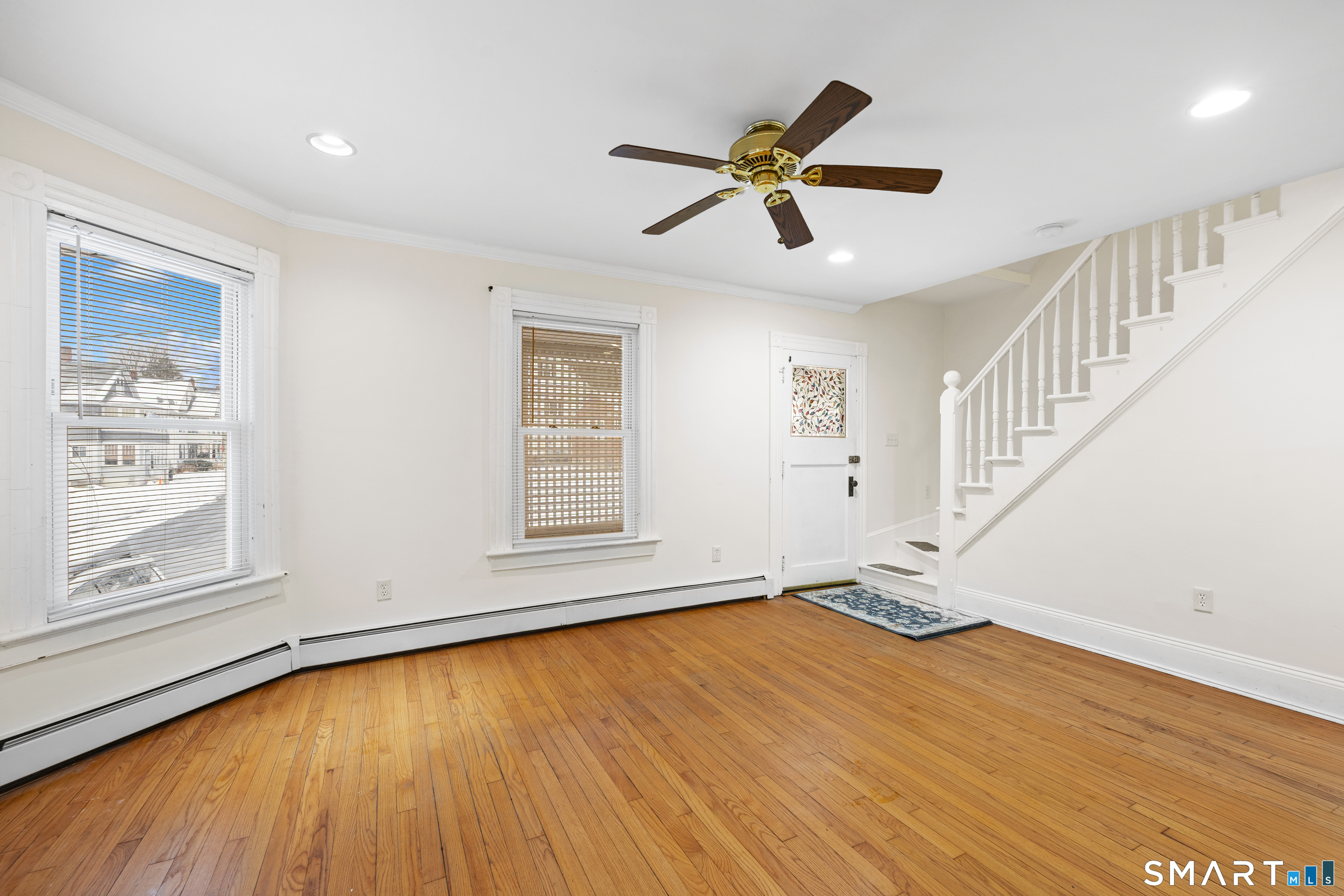 60 Guilford Street Torrington, CT 06790 - Photo 6 of 27 a view of an empty room with wooden floor and a window