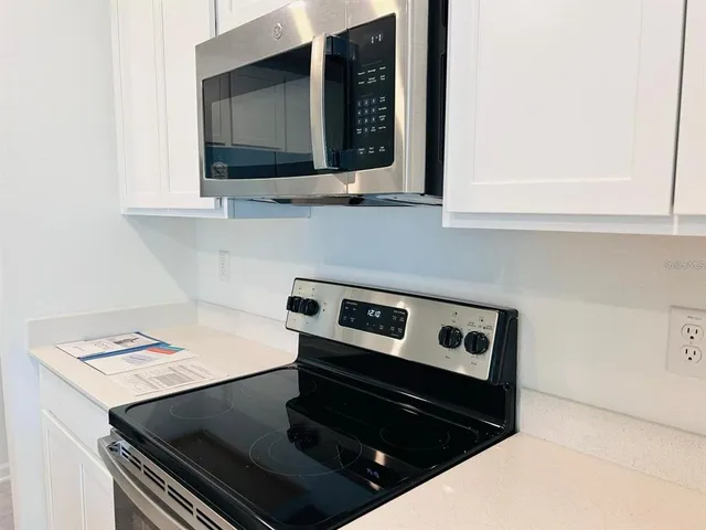 a kitchen with a stove and a microwave