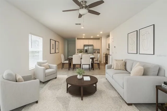 a living room with furniture and a large window