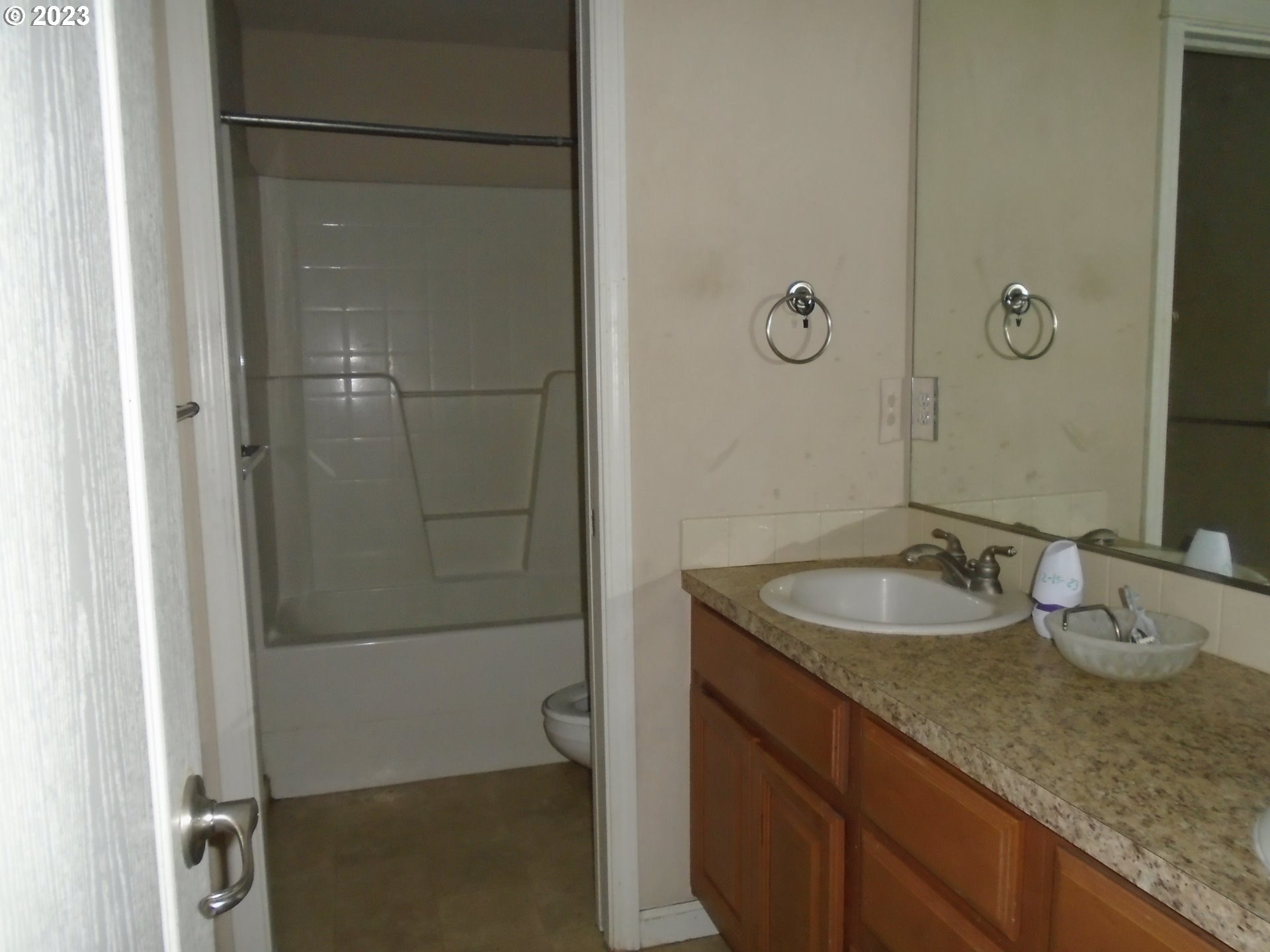 1710 South Dusky Drive Ridgefield, WA 98642 - Photo 13 of 16 a bathroom with a granite countertop sink a mirror and shower