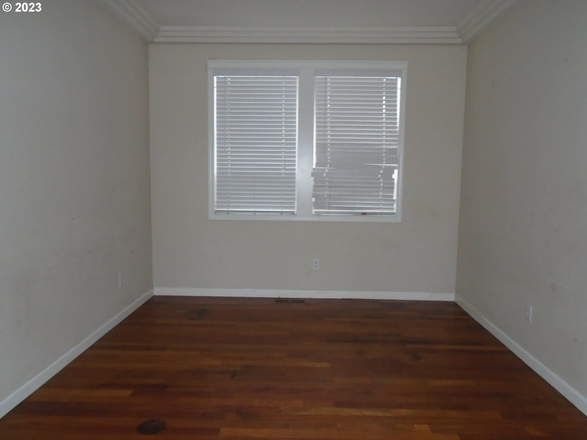 1710 South Dusky Drive Ridgefield, WA 98642 - Photo 3 of 16 a view of an empty room with wooden floor and a window