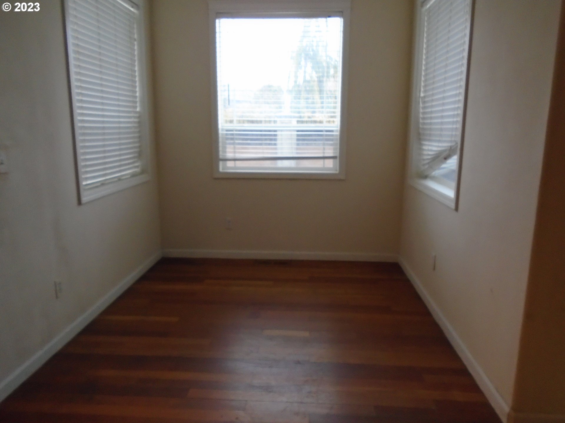 1710 South Dusky Drive Ridgefield, WA 98642 - Photo 5 of 16 a view of a hallway with wooden floors and a window