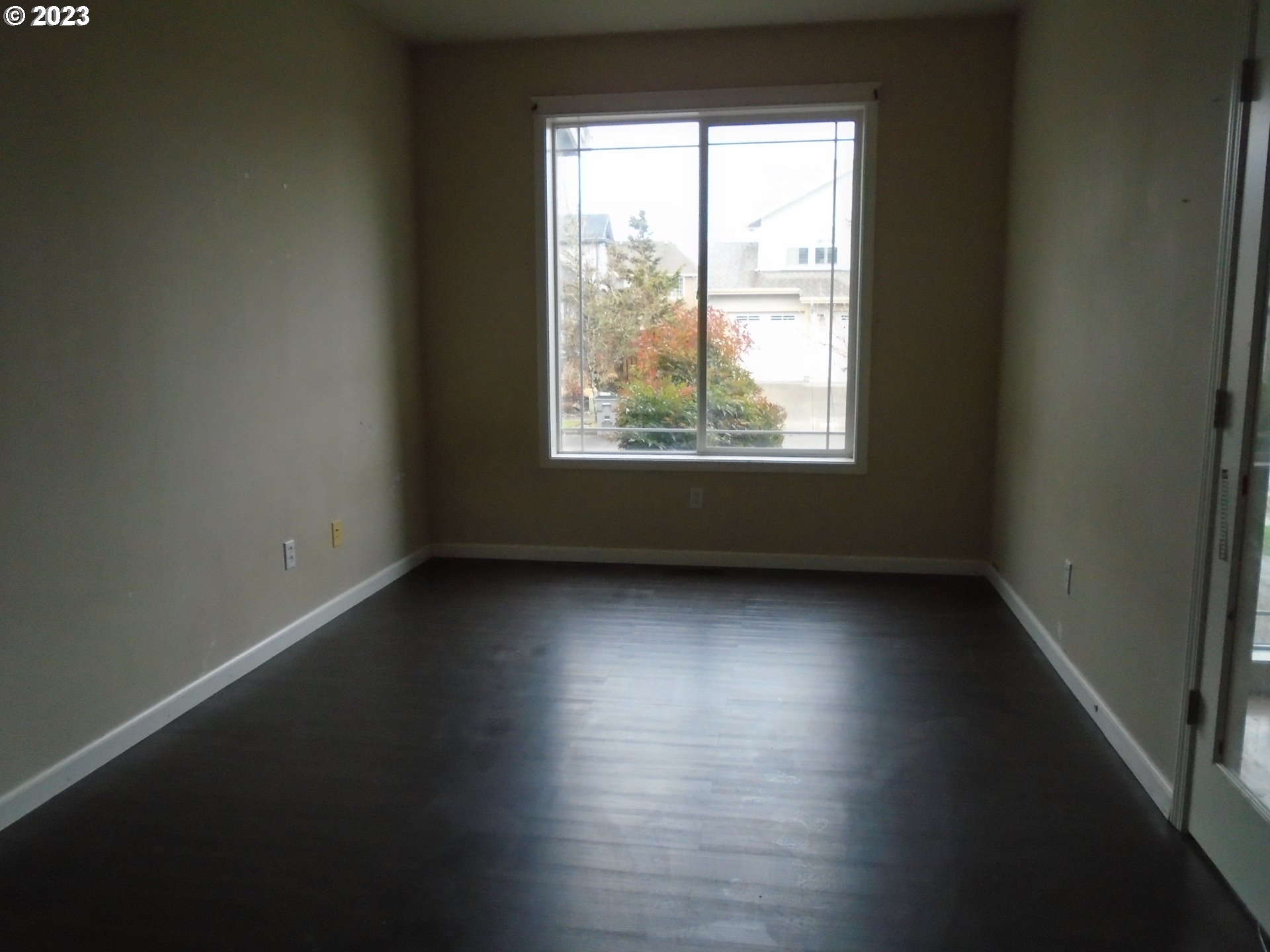 1710 South Dusky Drive Ridgefield, WA 98642 - Photo 7 of 16 an empty room with wooden floor and windows