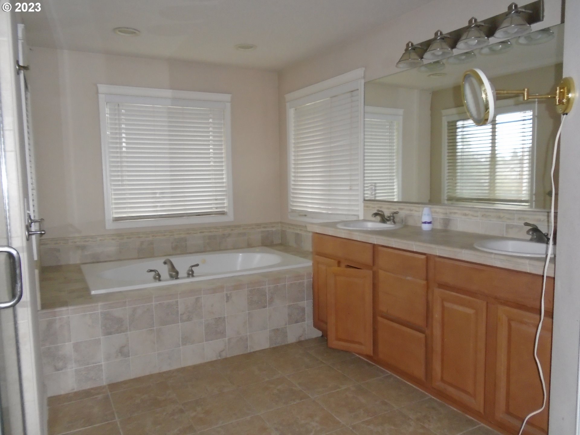 1710 South Dusky Drive Ridgefield, WA 98642 - Photo 9 of 16 a bathroom with a granite countertop tub sink and mirror