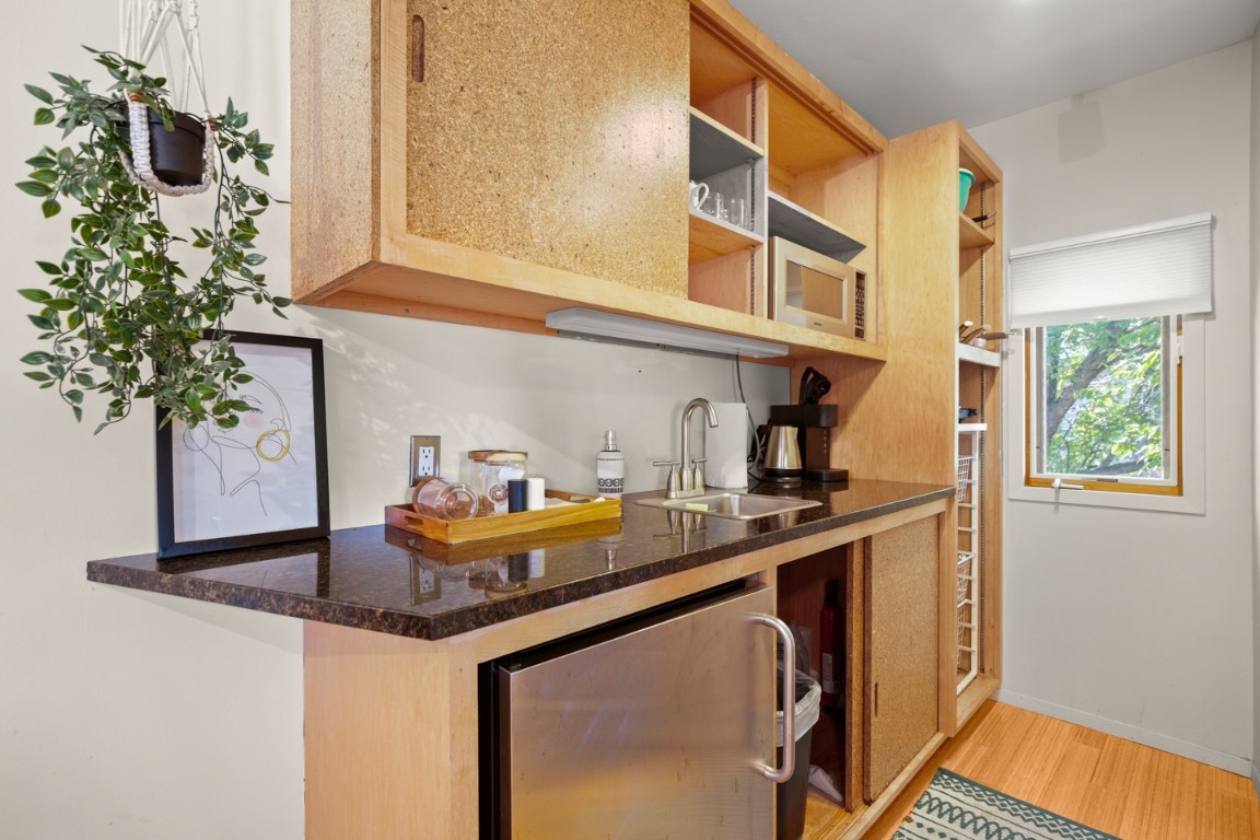 1406 Summit Street Austin, TX 78741 - Photo 30 of 32 a kitchen with a sink and a potted plant next to a window