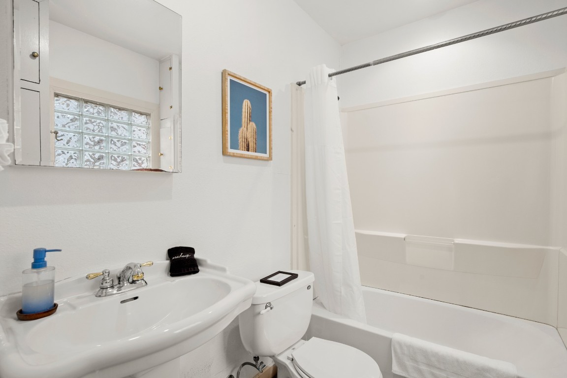 1406 Summit Street Austin, TX 78741 - Photo 10 of 32 a bathroom with a sink a toilet and shower