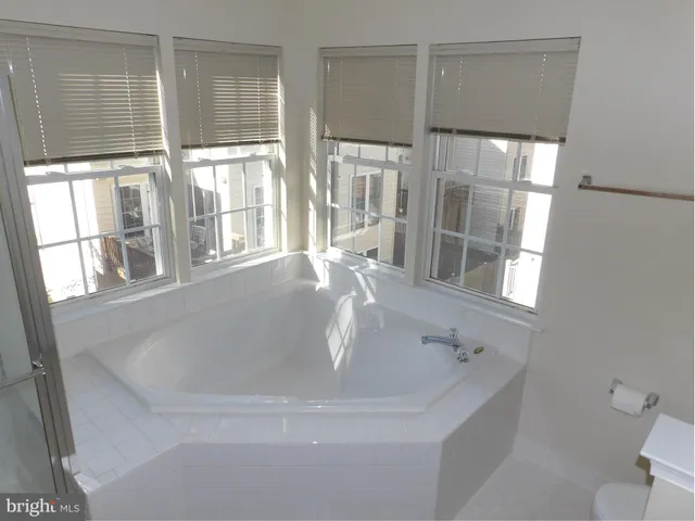 a bath tub sitting next to a window
