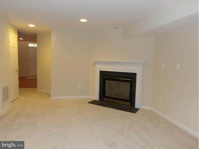 a view of an empty room with a fireplace